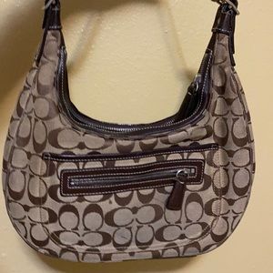 A Unworn U shaped coach shoulder bag